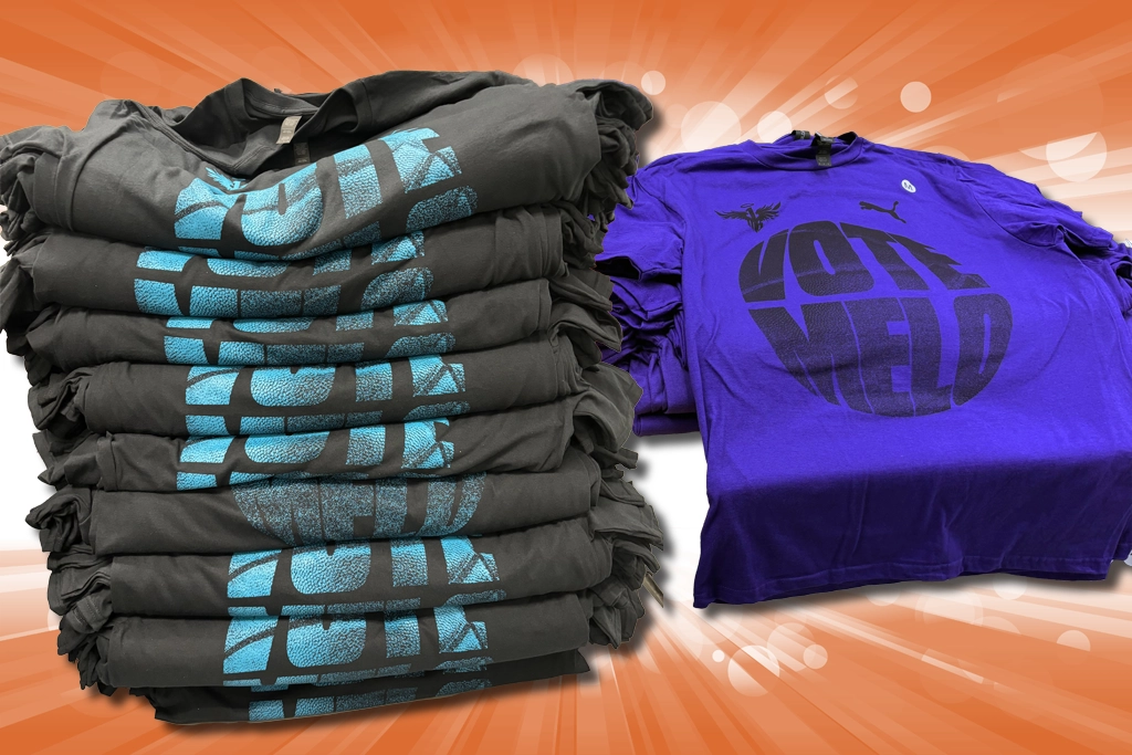 Screen printing press applying ink to shirts in a multi-color production setup